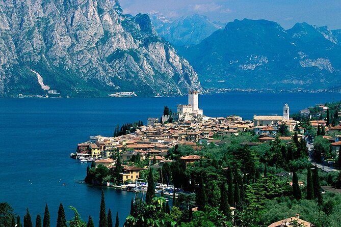 Full-Day Luxury Touch Lake Como Private Guided Tour - Entering Lake Como by ferry, with a guide doing the hard parts